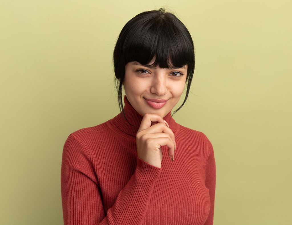 Young woman with dark hair and bangs